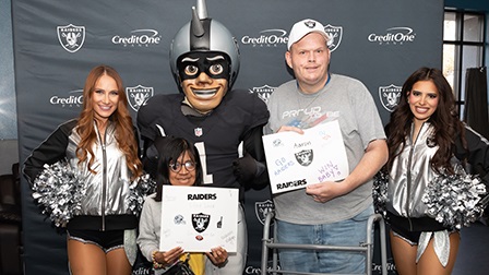 Recipients meet the Raider mascots and two cheerleaders