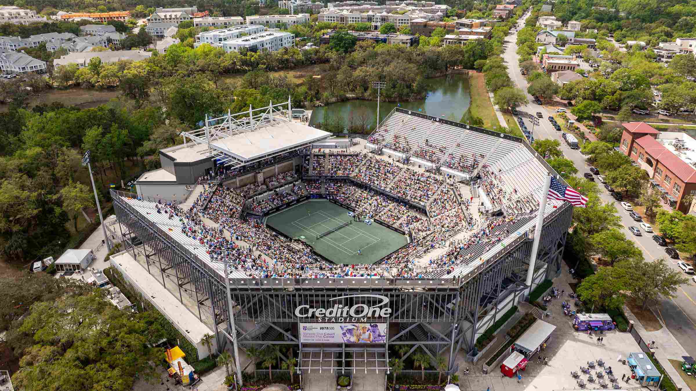 An aerial shot of the Credit One Stadium. The stadium is packed with audience members. 